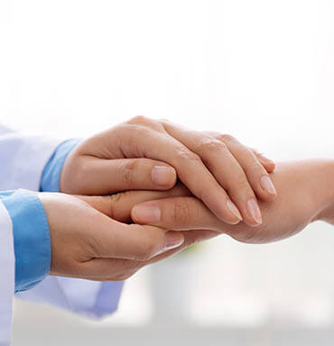 Doctor Holding a Patient's Hand