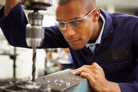 Man in workshop wearing safety glasses