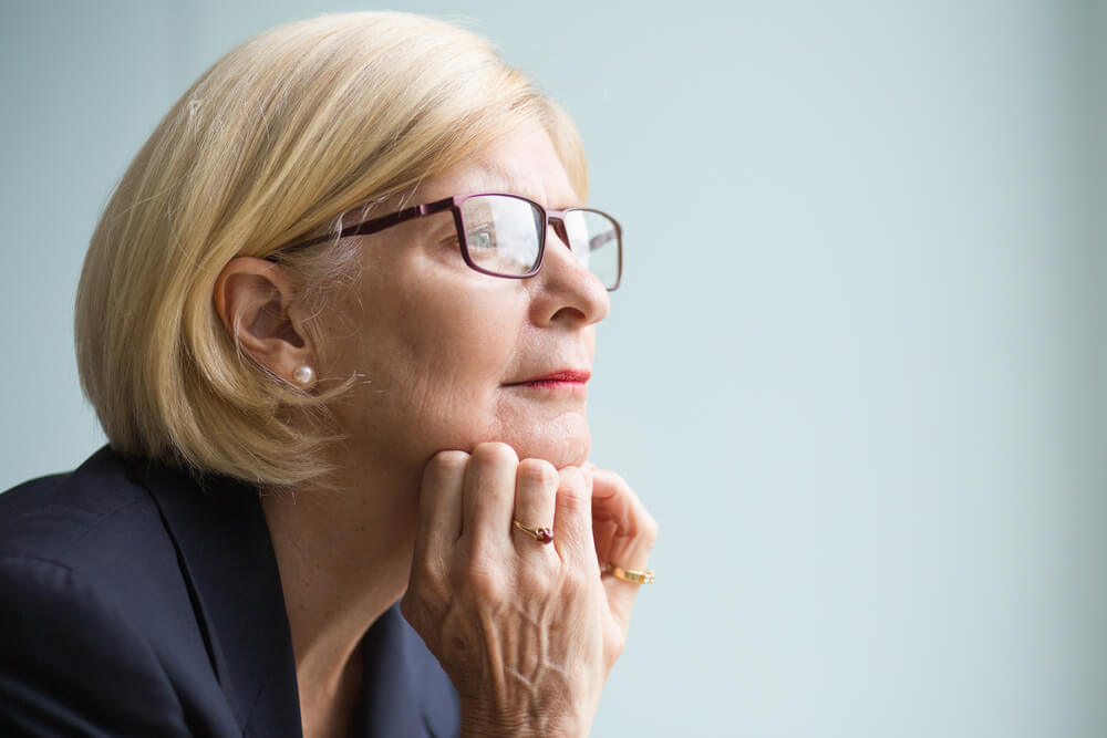 Professional older woman looking thoughtful
