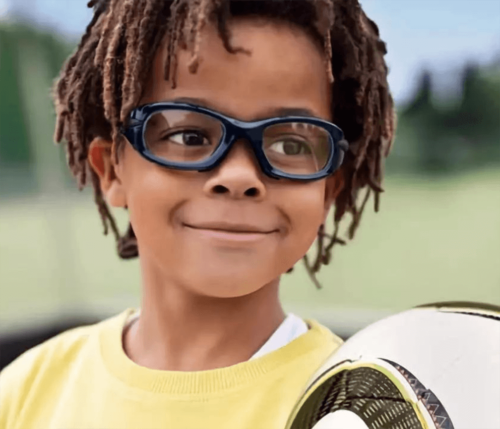 Boy playing soccer wearing goggles
