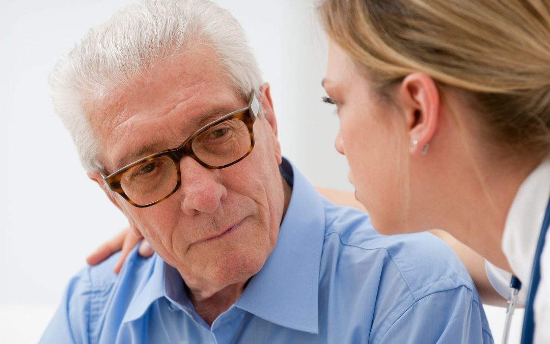 Eye doctor examining older man