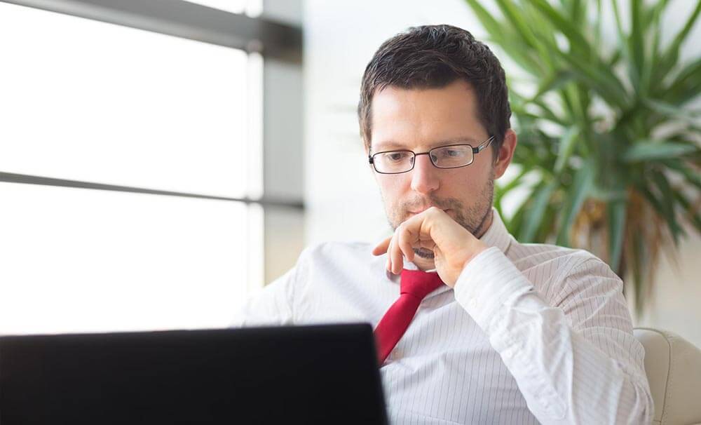 Professional man looking at laptop