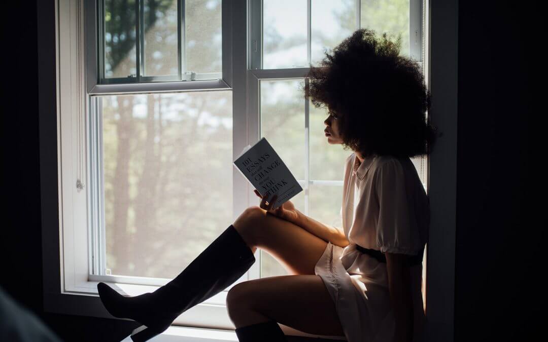 Woman in window reading book