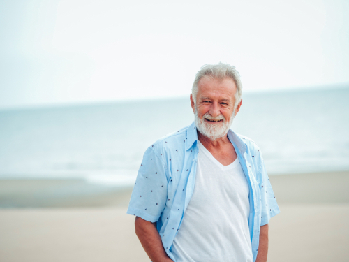 man walking down beach front