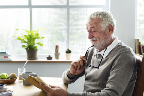 Older man reading book