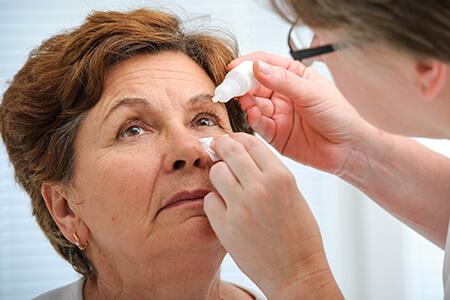 Woman getting eye drops for allergy relief
